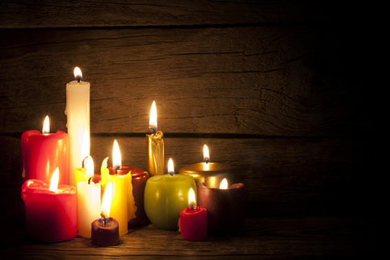 Candles in night in christmas mood on vintage wooden boards